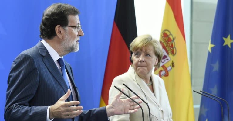 German Chancellor Angela Merkel (R) and Spanish Prime Minister Mariano Rajoy attend a press conference following talks at the Chancellery in Berlin on September 1, 2015