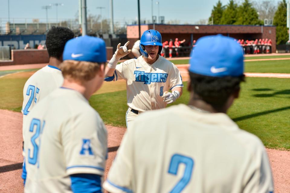 Memphis outfielder Jacob Compton (8) celebrates with teammates during an NCAA baseball game against Southern Illinois Edwardsville on Sunday, March 20, 2022 in Memphis. (AP Photo/Brandon Dill)