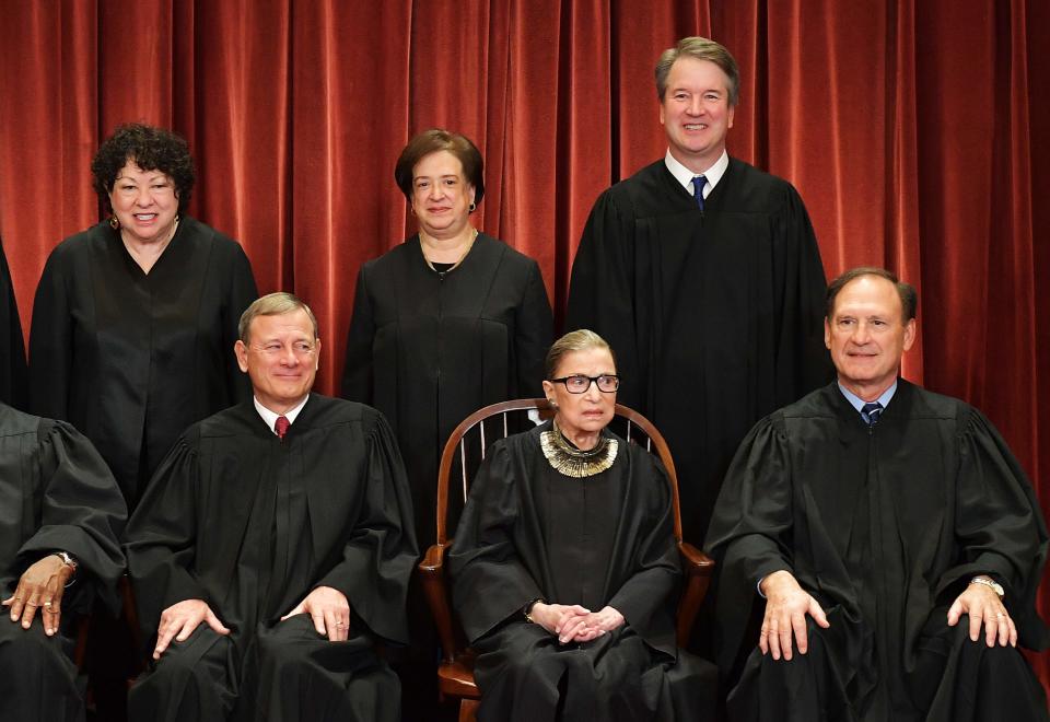 Associate Justice Brett Kavanaugh, top right, towers over his colleagues in this photo and is better known, following his contentious Senate confirmation battle last year, according to a poll by Marquette University Law School. Associate Justice Ruth Bader Ginsburg, seated, is a close second.