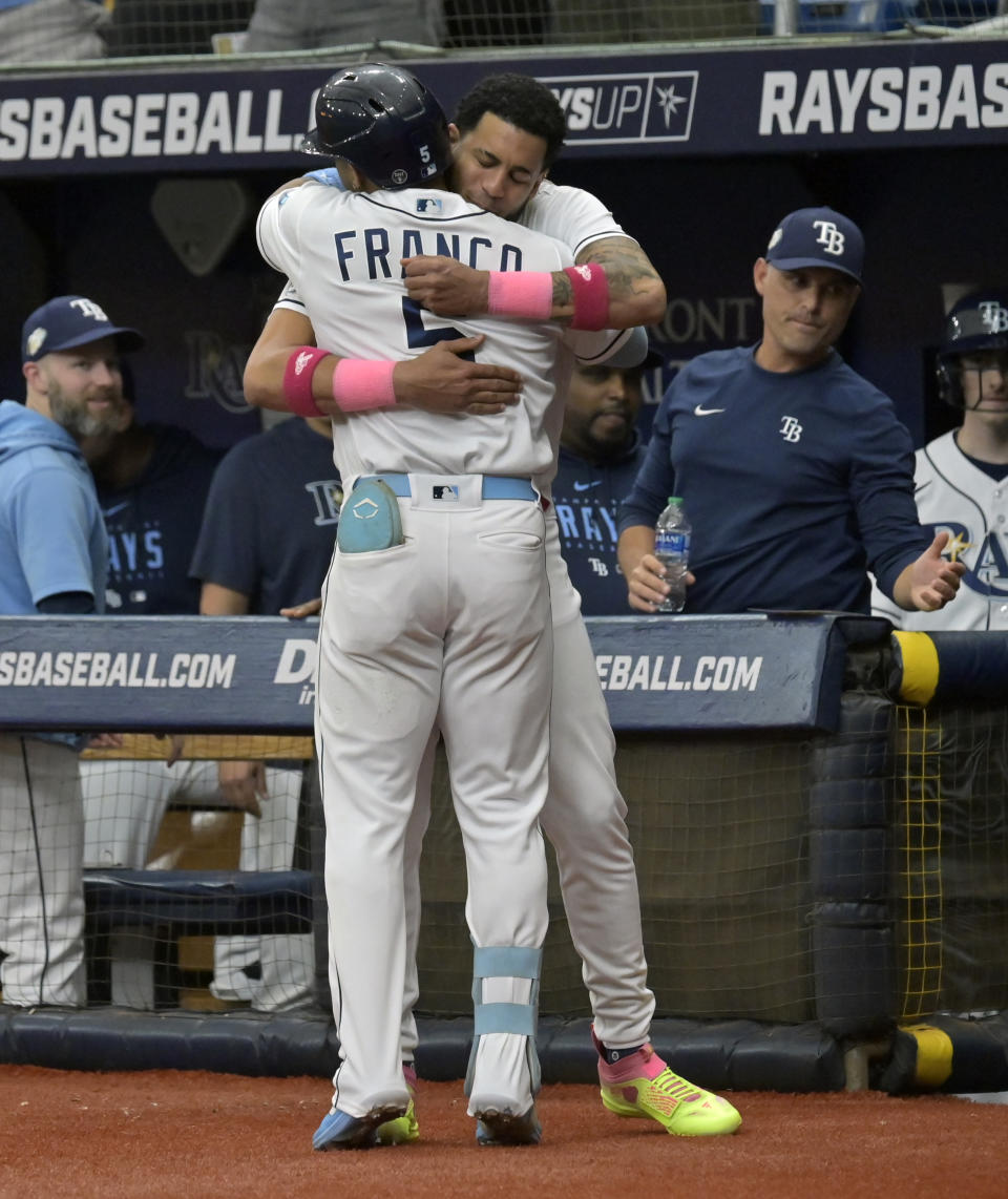 Tampa Bay Rays' Jose Siri comes out of the dugout to congratulate Wander Franco (5) after Franco's solo home run off Kansas City Royals starter Jotrdan Lyles during the first inning of a baseball game Saturday, June 24, 2023, in St. Petersburg, Fla. (AP Photo/Steve Nesius)