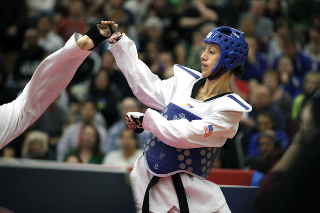 Diana Lopez backs away from a kick by Danielle Holmquist during the 2012 Taekwondo Olympic Trials at the U.S. Olympic Training Center on March 10, 2012 in Colorado Springs, Colorado. Lopez won the match 3-1. (Photo by Marc Piscotty/Getty Images)