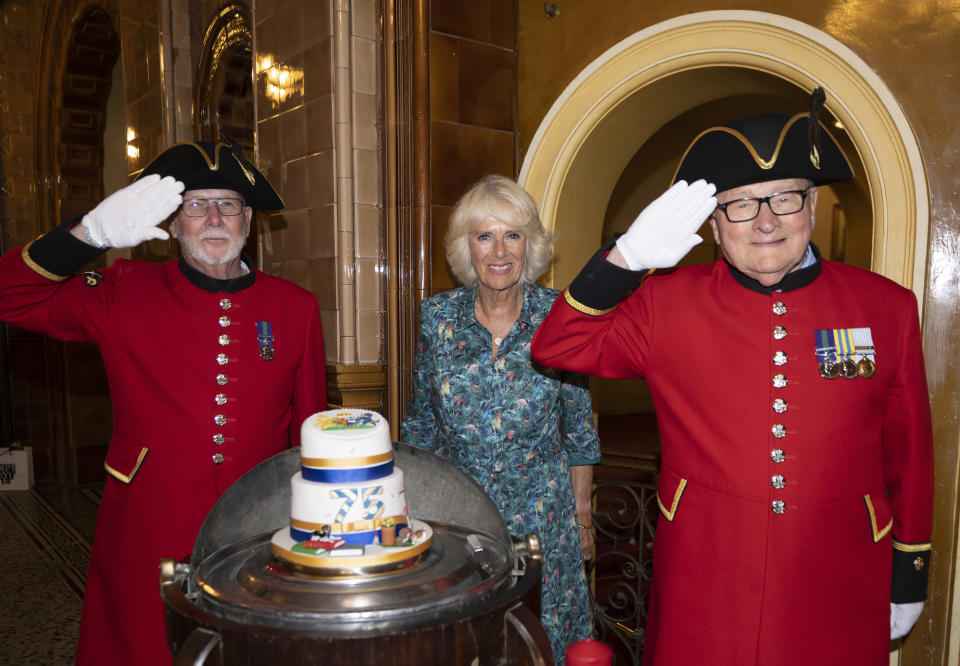 LONDON, ENGLAND- JULY 12: Camilla, Duchess of Cornwall poses with Chelsea Pensioners and a cake he cake which has representations of her racing colours and favorite pets as the Duchess celebrates her 75th birthday at a lunch, hosted by the Oldie Magazine at the National Liberal Club on July 12, 2022 in London, England. The lunch organized by Gyles Brandreth and the Oldie was arranged to celebrate the Duchess's birthday but also celebrates people over the age of 75 who are continuing to serve. The theme is 