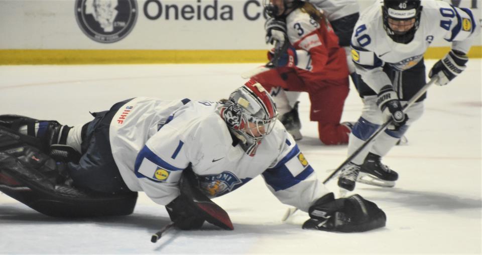 Finland goalie Sanni Ahola pounces to cover a loose puck against Czechia during the bronze medal game at the IIHF Women's World Championship at the Adirondack Bank Center.