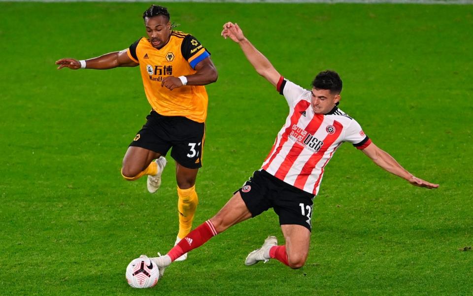 Wolverhampton's Adama Traore (L) in action against Sheffield's John Egan - Laurence Griffiths/POOL/EPA-EFE/Shutterstock