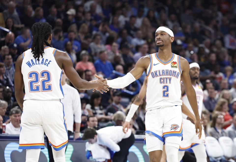 Apr 12, 2024; Oklahoma City, Oklahoma, USA; Oklahoma City Thunder guard Shai Gilgeous-Alexander (2) and guard Cason Wallace (22) high five during the second quarter against the Milwaukee Bucks at Paycom Center. Mandatory Credit: Alonzo Adams-USA TODAY Sports