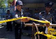 Polices stand guard during a protest by Buddhist monks and activists from Myanmar in front of the Thai embassy in Yangon, Myanmar, against the Thai military government invoking a special emergency law to let authorities search the Dhammakaya Temple in an attempt to arrest a former abbot, February 24, 2017. REUTERS/Soe Zeya Tun