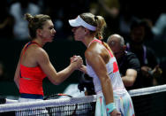 Tennis - Singapore WTA Finals Round Robin Singles - Singapore Indoor Stadium, Singapore - 25/10/2016 - Angelique Kerber of Germany (R) is congratulated by Simona Halep of Romania REUTERS/Edgar Su