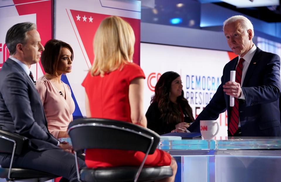 Democratic presidential hopeful former US vice president Joe Biden talks with moderators (L-R) Univision's journalist Ilia Calderon, CNN chief Washington correspondent Jake Tapper and CNN political correspondent Dana Bash at the end of the 11th Democratic Party 2020 presidential debate in a CNN Washington Bureau studio in Washington, DC on March 15, 2020. (Photo by MANDEL NGAN / AFP) (Photo by MANDEL NGAN/AFP via Getty Images)