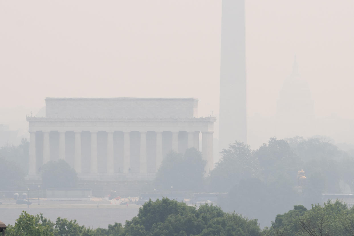 The Lincoln Memorial, left, and the Washington Monument in Washington, D.C., are enveloped in a smoky haze.