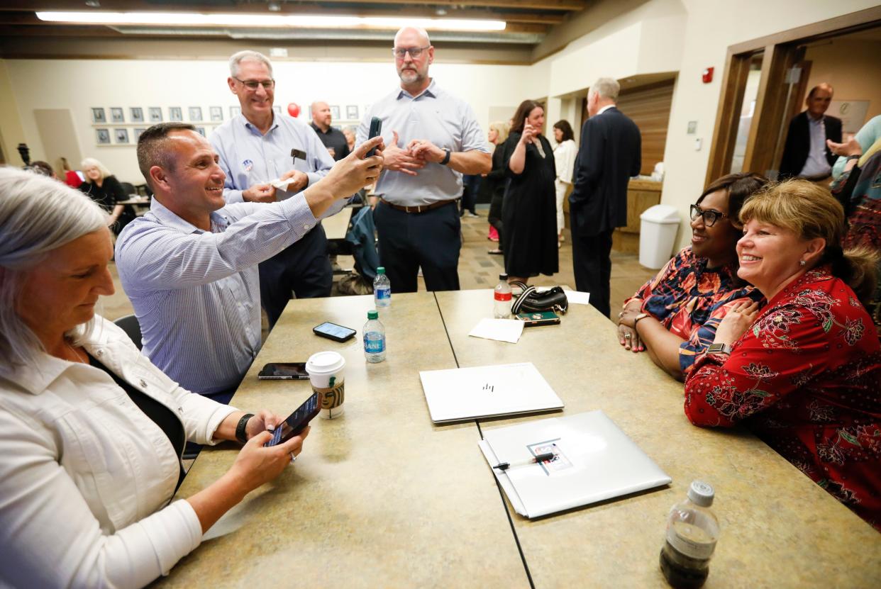 Superintendent Grenita Lathan and school board president Denise Fredrick pose for a photo shot by John Mulford, deputy superintendent of operations. David Hall, co-chair of the Community Task Force on Facilities, and Travis Shaw, who oversaw projects funded with the 2019 bond issue, stand nearby.