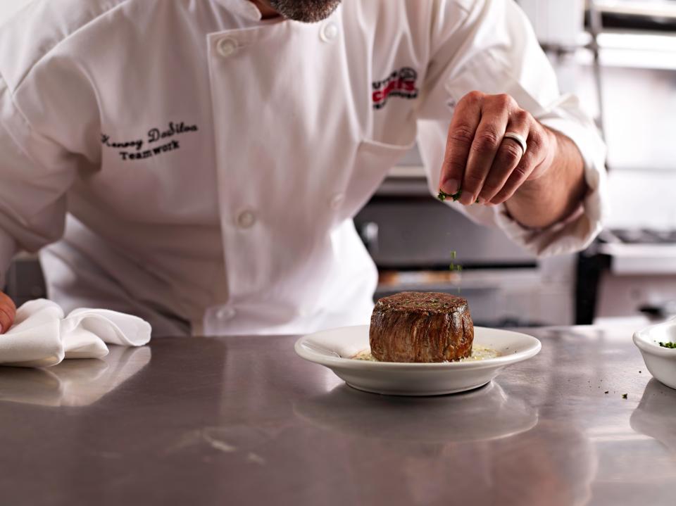 Final touches on a filet mignon at Ruth's Chris Steakhouse.