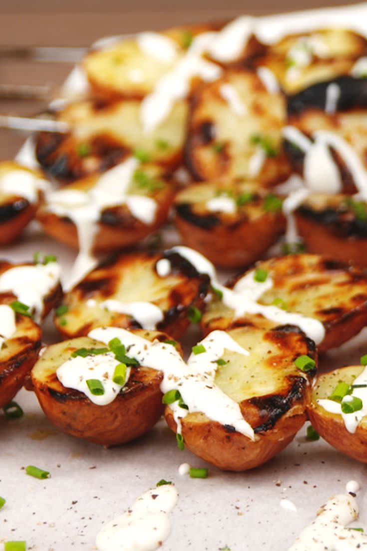 <p>Grilling baby potatoes are the perfect way to incorporate creamy, delicious potatoes to your next BBQ without having to step foot inside the kitchen. We take these spuds to the next level with two levels of <a href="https://www.delish.com/cooking/recipe-ideas/a25634518/ranch-dressing-recipe/" rel="nofollow noopener" target="_blank" data-ylk="slk:ranch dressing;elm:context_link;itc:0;sec:content-canvas" class="link ">ranch dressing</a> goodness: The seasoning adds some salty, umami flavor while the dressing provides that cooling, tangy creaminess.</p><p>Get the <strong><a href="https://www.delish.com/cooking/recipe-ideas/recipes/a53181/grilled-ranch-potatoes-recipe/" rel="nofollow noopener" target="_blank" data-ylk="slk:Grilled Ranch Potatoes recipe;elm:context_link;itc:0;sec:content-canvas" class="link ">Grilled Ranch Potatoes recipe</a>.</strong></p>