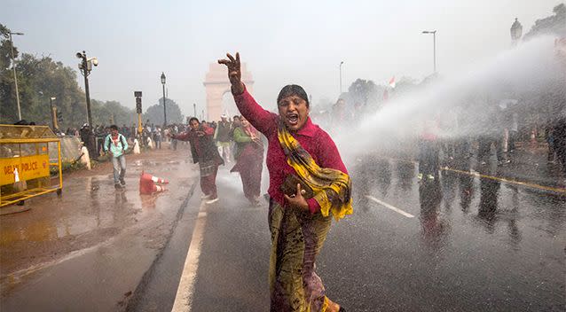 Unrest over violence against women has been growing in India for years. This photo from a 2012 protest shows a woman bracing in the face of water canon while protesting rape laws. Photo: Getty Images