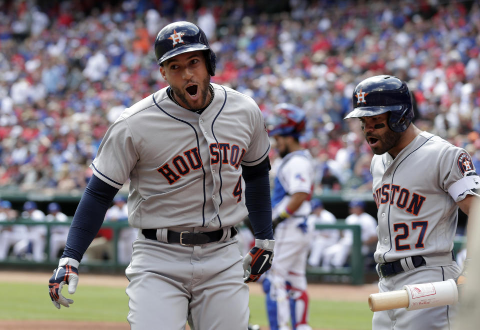 Houston Astros’ George Springer (4) celebrates his solo home run with Jose Altuve (27) in the first inning of a baseball game against the Texas Rangers in Arlington, Texas, Thursday, March 29, 2018. (AP Photo/Tony Gutierrez)