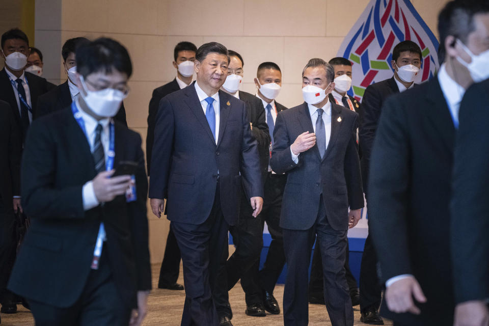 Chinese President Xi Jinping, center left, and Chinese Foreign Minister Wang Yi, center right, arrive to attend the APEC Economic Leaders Meeting during the Asia-Pacific Economic Cooperation, APEC summit, Saturday, Nov. 19, 2022, in Bangkok, Thailand. (Haiyun Jiang/The New York Times via AP, Pool)