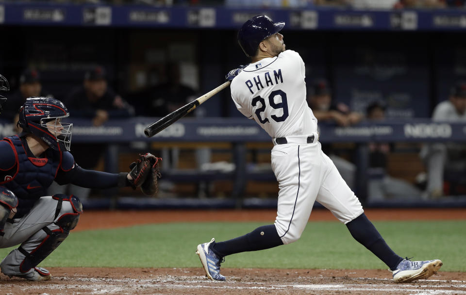 Tampa Bay Rays' Tommy Pham (29) watches his two-run home run off Cleveland Indians starting pitcher Zach Plesac during the third inning of a baseball game Saturday, Aug. 31, 2019, in St. Petersburg, Fla. Catching for Cleveland is Roberto Perez. (AP Photo/Chris O'Meara)