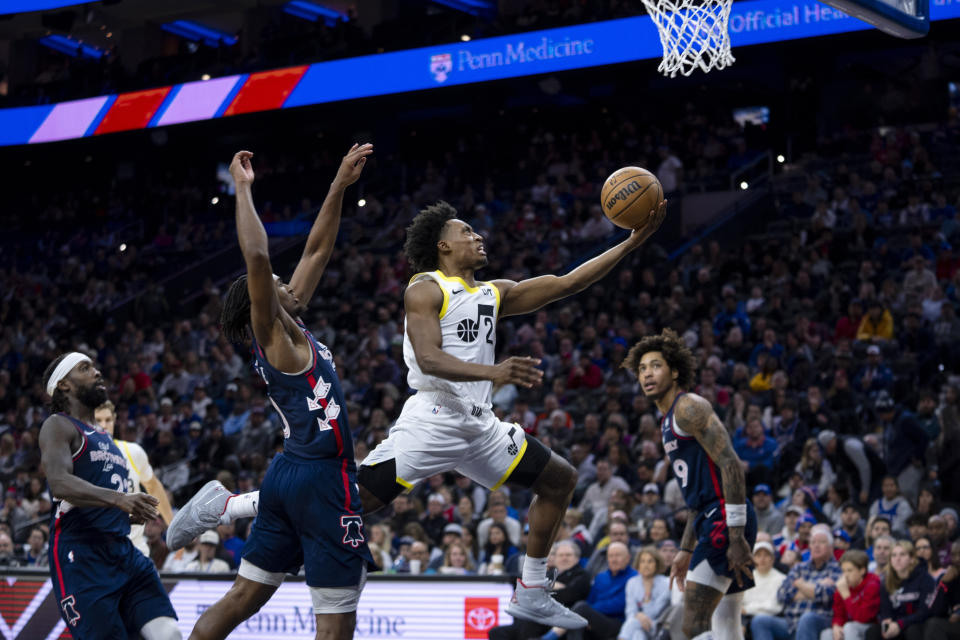 Utah Jazz's Collin Sexton goes up for the lay-up as he passes Philadelphia 76ers' Tyrese Maxey, center left, during the second half of an NBA basketball game Saturday, Jan. 6, 2024, in Philadelphia. The Jazz won 120-109. (AP Photo/Chris Szagola)