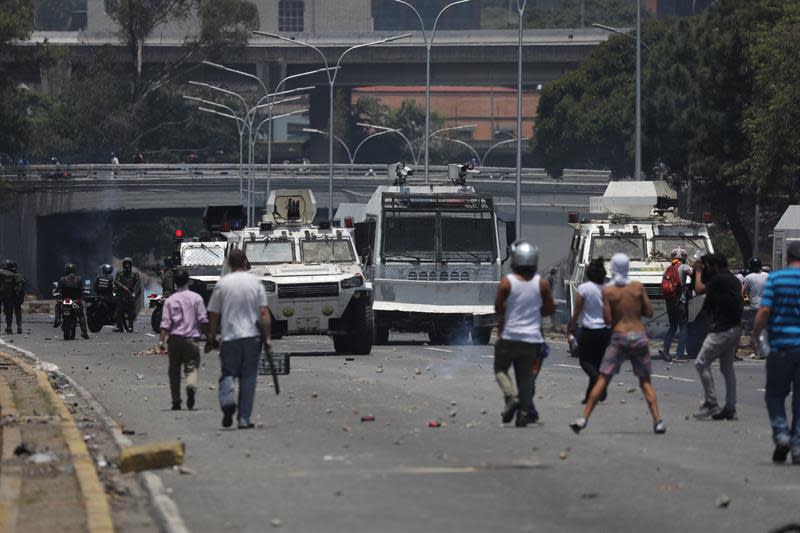 Simpatizantes del presidente de la Asamblea Nacional, Juan Guaidó, protestan frente a una tanqueta durante una manifestación en apoyo a su levantamiento contra el gobierno de Nicolás Maduro este martes, en la zona de Altamira, en Caracas (Venezuela). EFE