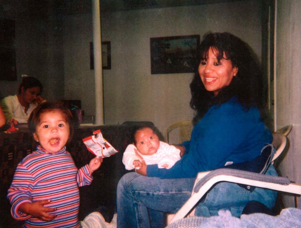 Melissa Lucio holding her daughter Mariah with one of her other daughters Adriana standing next to her (the family of Melissa Lucio)