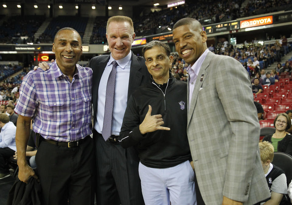 FILE -- Former San Francisco 49ers running back Roger Craig, left, NBA Hall of Fame guard Chris Mullen, second from left, Sacramento Kings majority owner Vivek Ranadive, third from left and Sacramento Mayor Kevin Johnson, right, pose for a photo before the start of the Kings NBA preseason basketball game against the Los Angeles Clippers in Sacramento, Calif., Monday, Oct. 14, 2013. Ranadive, a successful Silicon Valley software pioneer, emerged at the intersection of politics and sports last year as he led a consortium of owners to purchase the Sacramento Kings, becoming the leagues first Indian-American owner.(AP Photo/Rich Pedroncelli, File)