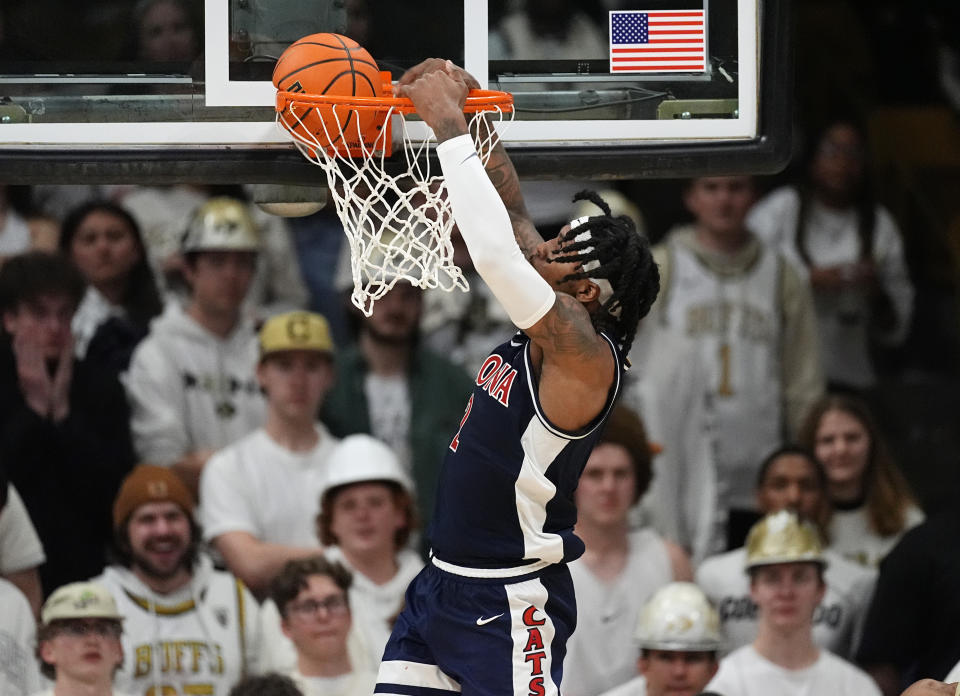 Arizona guard Caleb Love dunks against Colorado during the second half of an NCAA college basketball game Saturday, Feb. 10, 2024, in Boulder, Colo. (AP Photo/David Zalubowski)