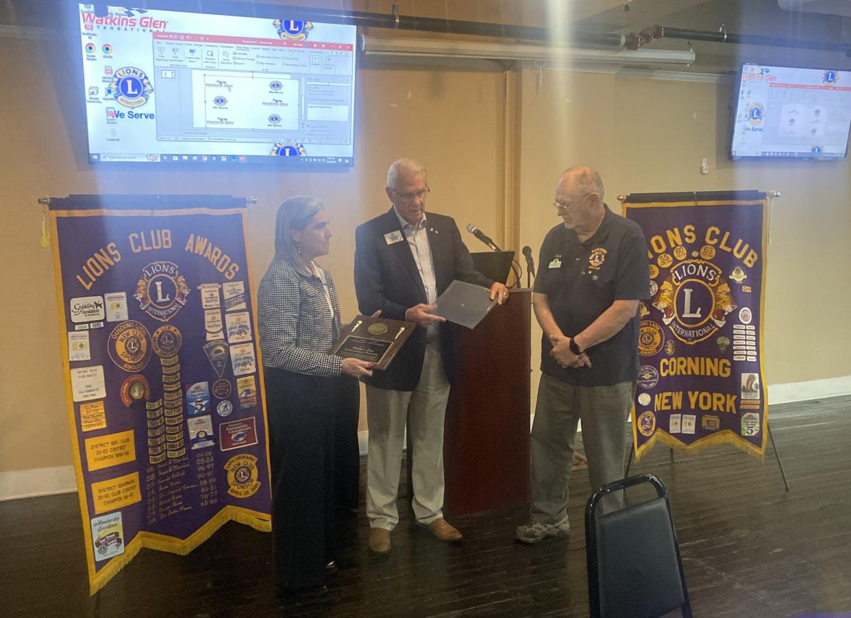 Watkins Glen International Racetrack President Dawn Burlew accepts the Robert J. Uplinger Distinguished Service Award Thursday night on behalf of the track and its support of the Corning Lions Club and the Greater Corning Area.