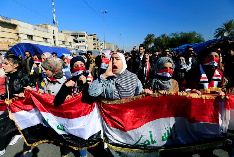 University students shout slogans, during ongoing anti-government protests in Baghdad