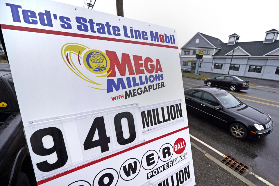 Cars pass a sign noting the Mega Millions jackpot outside Ted's State Line Mobil station, Thursday, Jan. 5, 2023, in Methuen, Mass. Twenty-three consecutive drawings later with no grand prize winner named, the Mega Millions jackpot is now flirting with nearly $1 billion, making it one of the largest jackpots in lottery history. (AP Photo/Charles Krupa)