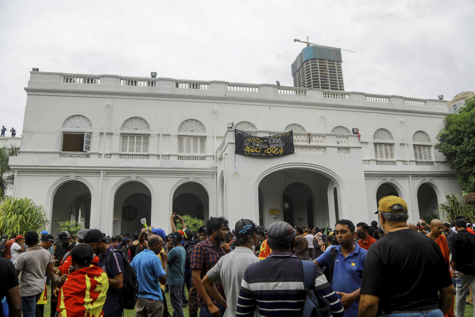 Protesters gather inside the premises of Sri Lankan presidents official residence in Colombo, Sri Lanka, Saturday, July 9, 2022. Sri Lankan protesters stormed President Gotabaya Rajapaksa’s residence and nearby office on Saturday as tens of thousands of people took to the streets of the capital Colombo in the biggest demonstration yet to vent their fury against a leader they hold responsible for the island nation’s worst economic crisis. (AP Photo/Amitha Thennakoon)