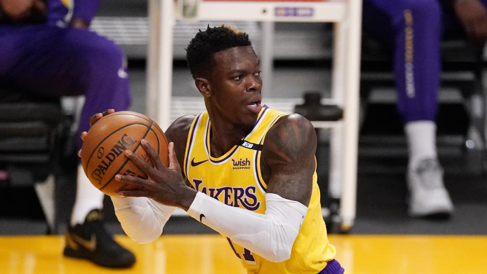 Los Angeles Lakers guard Dennis Schroder looks to pass the ball during the first half of an NBA basketball game against the Cleveland Cavaliers Friday, March 26, 2021, in Los Angeles. (AP Photo/Mark J. Terrill)