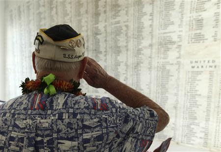 USS Arizona survivor Louis Conter salutes after placing a wreath at the "Remembrance Wall" on board the USS Arizona Memorial during the 72nd anniversary of the attack on Pearl Harbor at the WW II Valor in the Pacific National Monument in Honolulu, Hawaii on December 7, 2013. REUTERS/Hugh Gentry