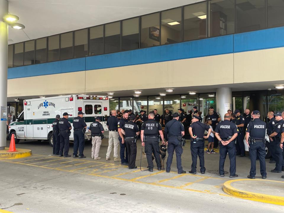 Law enforcement officers from around central Ohio gather Wednesday, July 26, 2023, outside OhioHealth Grant Medical Center as the Columbus police officer injured in a shootout July 6 on Interstate 70 is released.