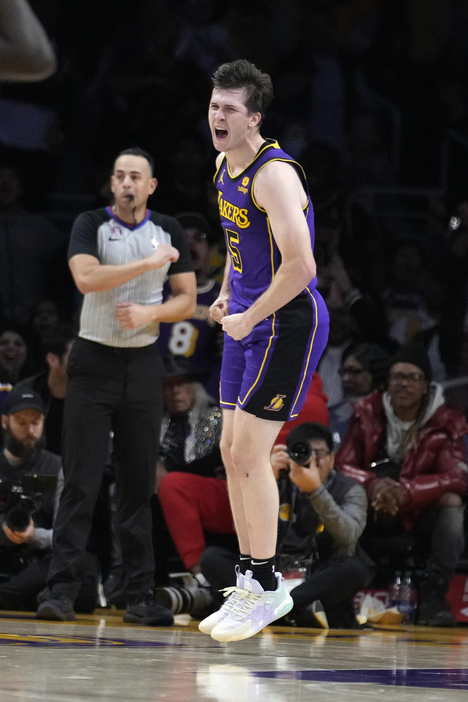 Los Angeles Lakers guard Austin Reaves celebrates after scoring against the Toronto Raptors during the second half of an NBA basketball game Friday, March 10, 2023, in Los Angeles. (AP Photo/Marcio Jose Sanchez)