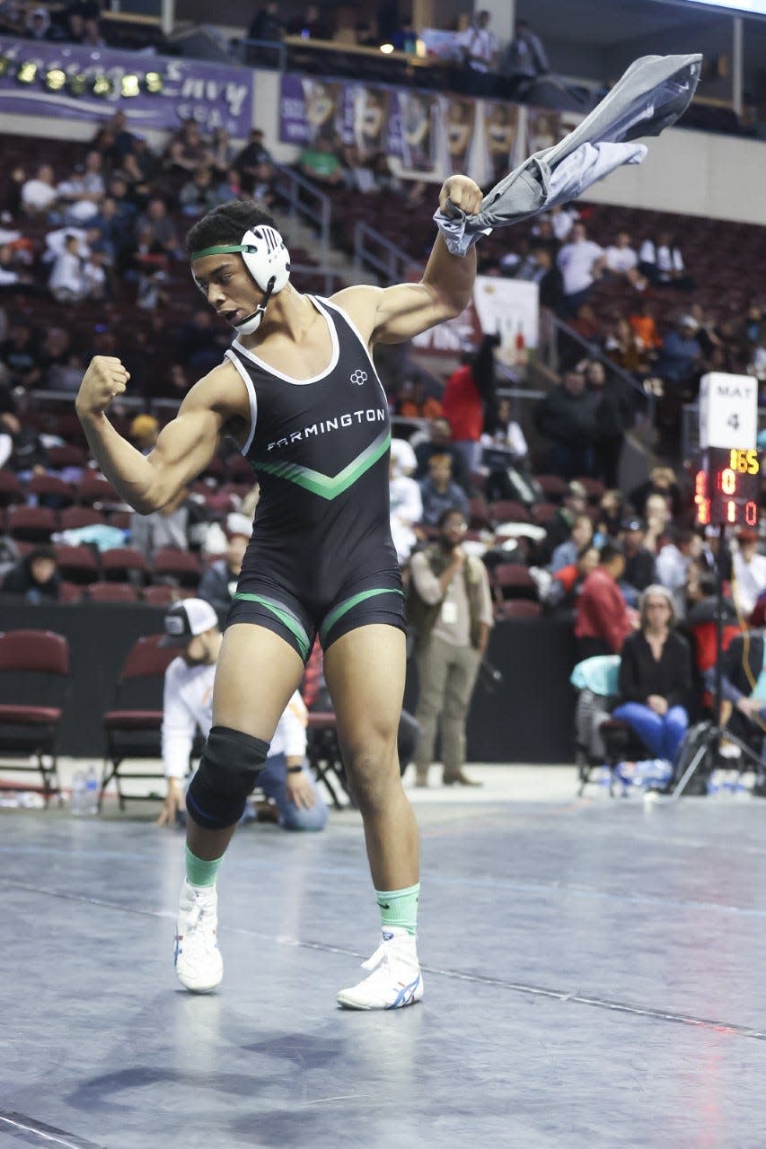 Farmington High School's Ivan Smith flexes after his 170 lbs. championship match win against Los Luna's Miguel Andrade on Saturday, Feb. 19, at Rio Rancho Events Center.