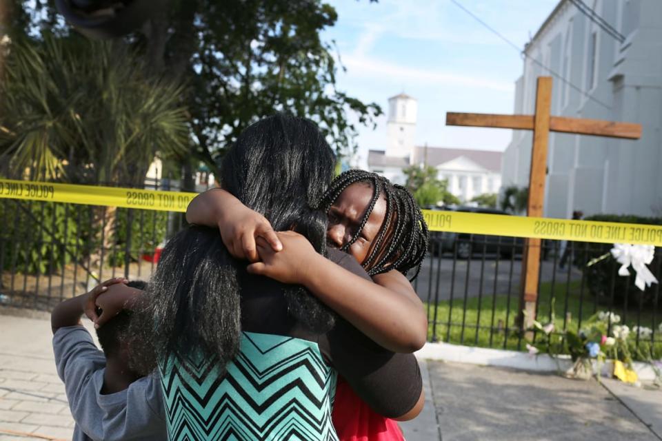 <div class="inline-image__caption"><p>\Kearston Farr comforts her daughter, Taliyah Farr,5, as they stand in front of the Emanuel African Methodist Episcopal Church after a mass shooting at the church that killed nine people of June 19, 2015. A 21-year-old white gunman is suspected of killing nine people during a prayer meeting in the church, which is one of the nation's oldest black churches in Charleston.</p></div> <div class="inline-image__credit">Joe Raedle/Getty</div>