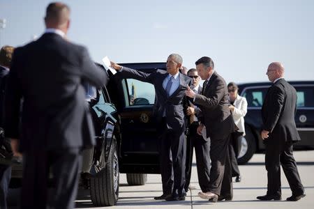President Obama talks to Nevada Governor Brian Sandoval as he arrives at McCarran International Airport in Las Vegas, August 24, 2015. REUTERS/Carlos Barria