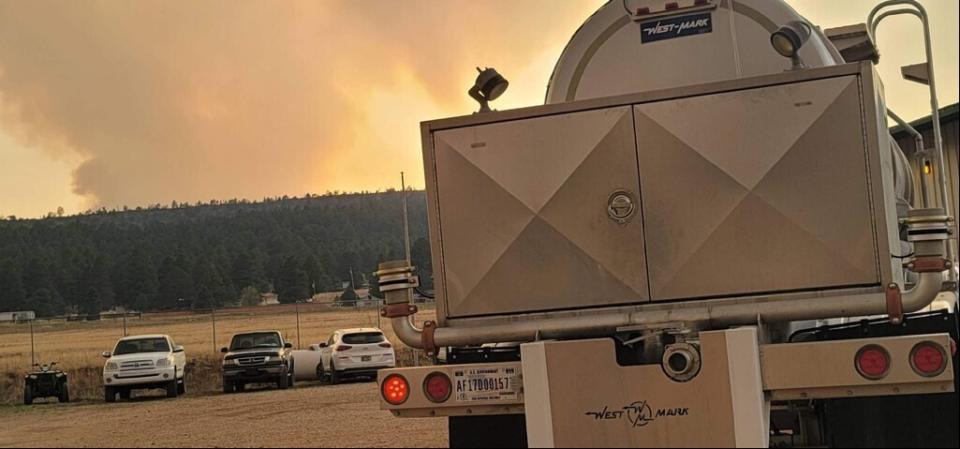 In this photo provided by the New Mexico National Guard, a New Mexico National Guard truck is ready to deliver potable water to communities in response to the Calf Canyon/Hermits Peak fire in northern New Mexico on Sunday, May 1, 2022. Thousands of firefighters battled destructive wildfires in the Southwest as more residents prepared to evacuate in northern New Mexico where strong winds and dangerously dry conditions have made the blazes hard to contain. (New Mexico National Guard via AP)