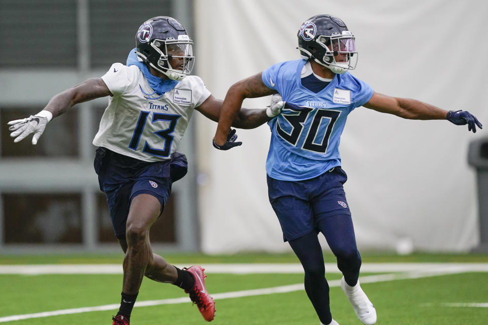 Tennessee Titans wide receiver Racey McMath (13) is defended by cornerback Greg Mabin (30) during training camp at the NFL football team's practice facility Friday, July 29, 2022, in Nashville, Tenn. (AP Photo/Mark Humphrey)