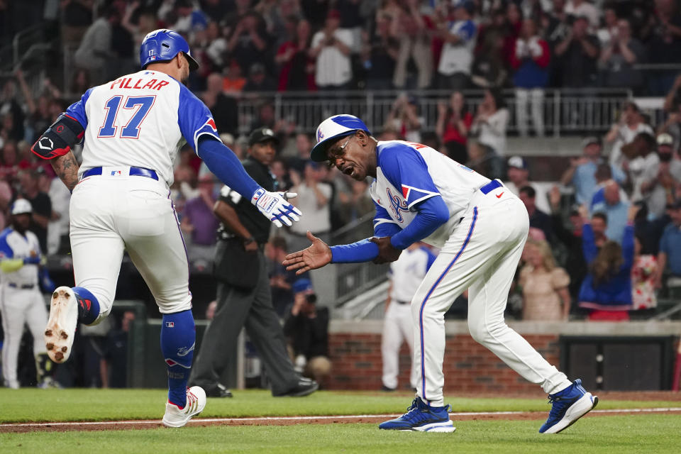 Atlanta Braves pinch hitter Kevin Pillar (17) celebrates with third base coach Ron Washington (37) as he rounds the bases after hitting a two-run home run in the eighth inning of a baseball game against the Baltimore Orioles Saturday, May 6, 2023, in Atlanta. (AP Photo/John Bazemore)