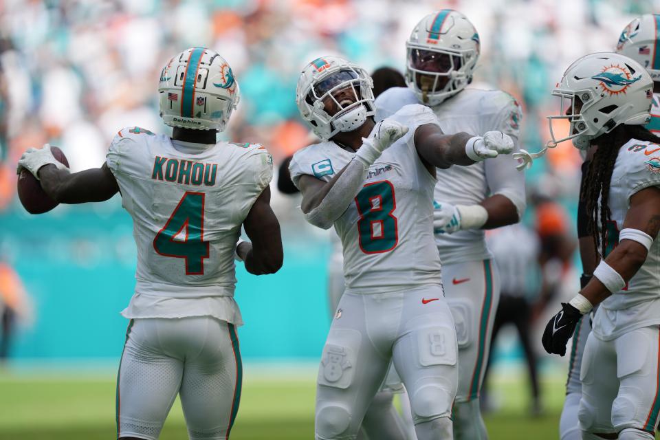 Miami Dolphins safety Jevon Holland (8) celebrates creating a turnover against the Denver Broncos that was recovered by cornerback Kader Kohou (4) during the second half of an NFL game at Hard Rock Stadium in Miami Gardens, Sept. 24, 2023.