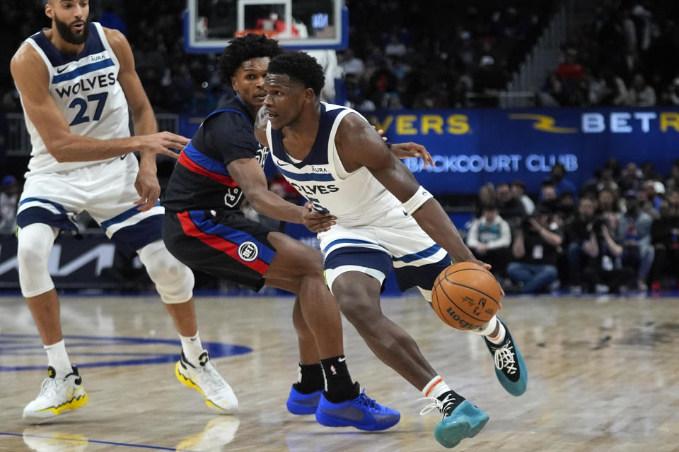 Minnesota Timberwolves guard Anthony Edwards (5) drives on Detroit Pistons forward Ausar Thompson (9) in the second half of an NBA basketball game in Detroit, Wednesday, Jan. 17, 2024. (AP Photo/Paul Sancya)