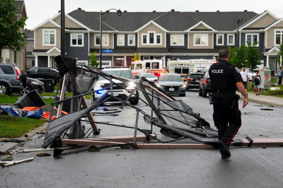 Debris fills a street following a tornado in the Ottawa suburb of Barrhaven on July 13, 2023.