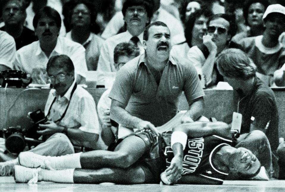 Isiah Thomas crumbled after a twisted ankle and is attended to by trainer Mike Abdenour at The Forum in Inglewood, California, during Game 6 of the NBA Finals on June 19, 1988.