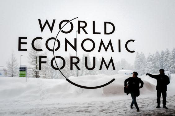 A security guard shows the way to a man outside the Davos Congress Centre (AFP/Getty)