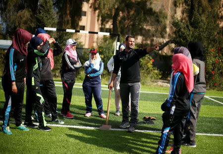 Palestinian baseball coach Mahmoud Tafesh gestures as he trains women in Khan Younis in the southern Gaza Strip March 19, 2017. REUTERS/Mohammed Salem