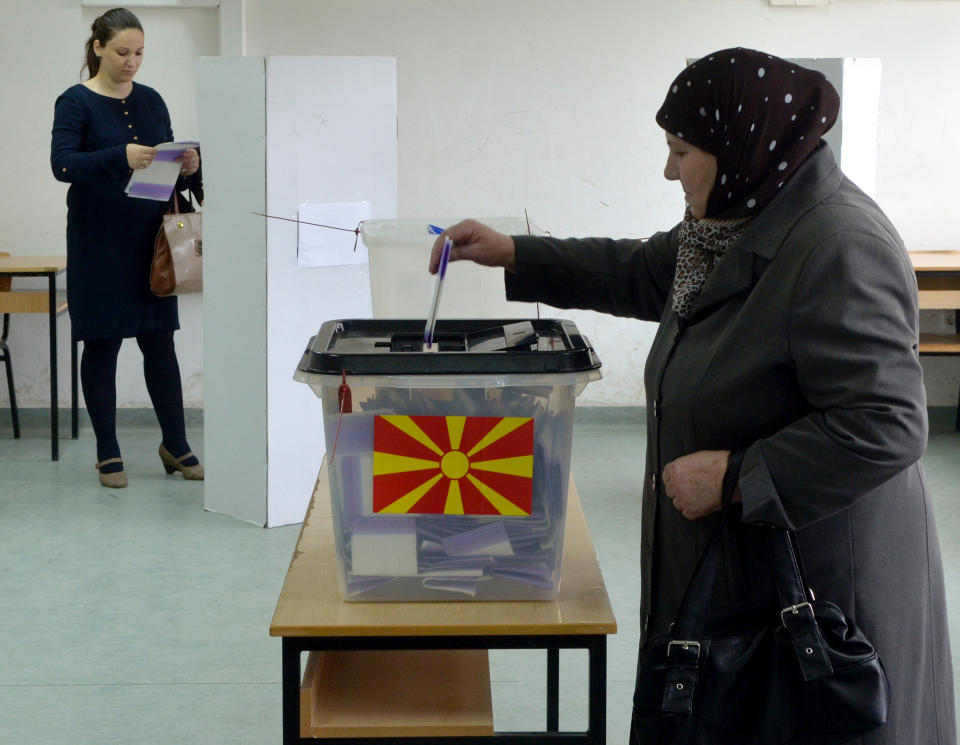 An ethnic Albanian woman casts her ballot at a polling station in Skopje, Macedonia, on Sunday, April 27, 2014. Macedonia votes Sunday on presidential election runoff and snap parliamentary elections. (AP Photo/Boris Grdanoski)