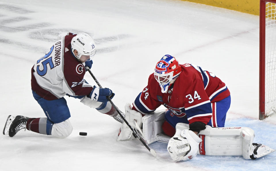 Colorado Avalanche's Logan O'Connor (25) moves in on Montreal Canadiens goaltender Jake Allen during the first period of an NHL hockey game in Montreal, Monday, March 13, 2023. (Graham Hughes/The Canadian Press via AP)