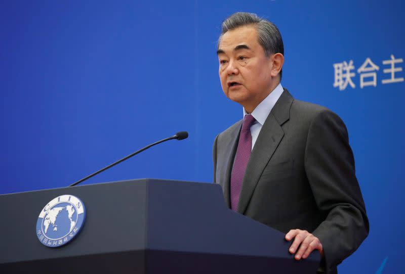 Chinese Foreign Minister Wang Yi delivers a speech at an annual symposium on international situation and China's diplomacy in Beijing