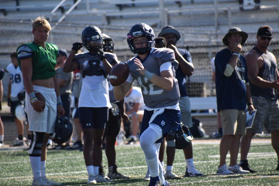 Decatur Central quarterback Bo Polston looks to throw a pass during the Hawks' four-way scrimmage with Bloomington North, Castle and Speedway on June 23, 2022.