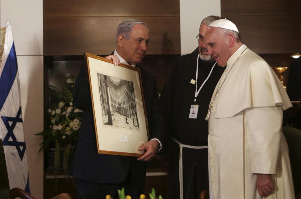 Israel's Prime Minister Benjamin Netanyahu presents a gift to Pope Francis during their meeting at the Notre Dame Center in Jerusalem